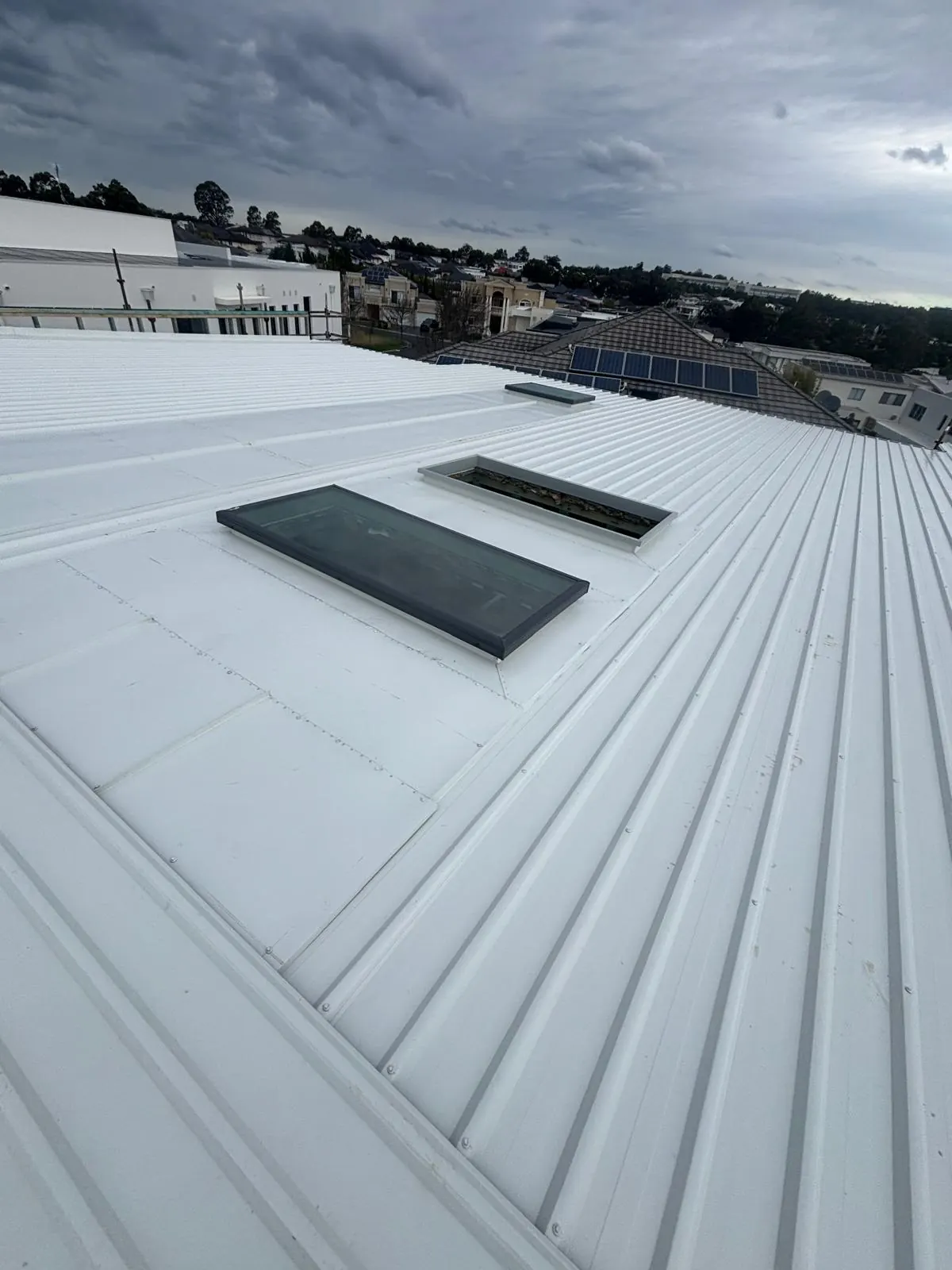 Metal roofing with skylight integration