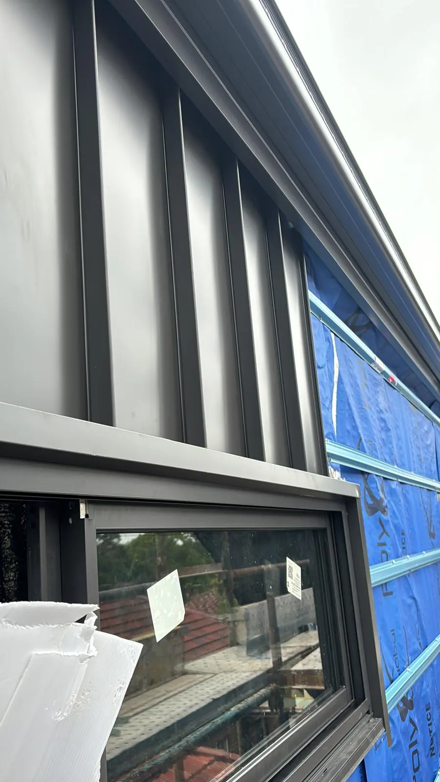 Metal wall cladding detail around a window